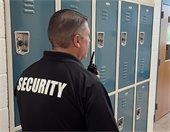 Security guard holding walkie talkie.