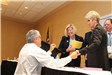 Participants shake hands at NJLM Business Meeting
