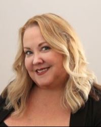 Blond haired woman smiling.